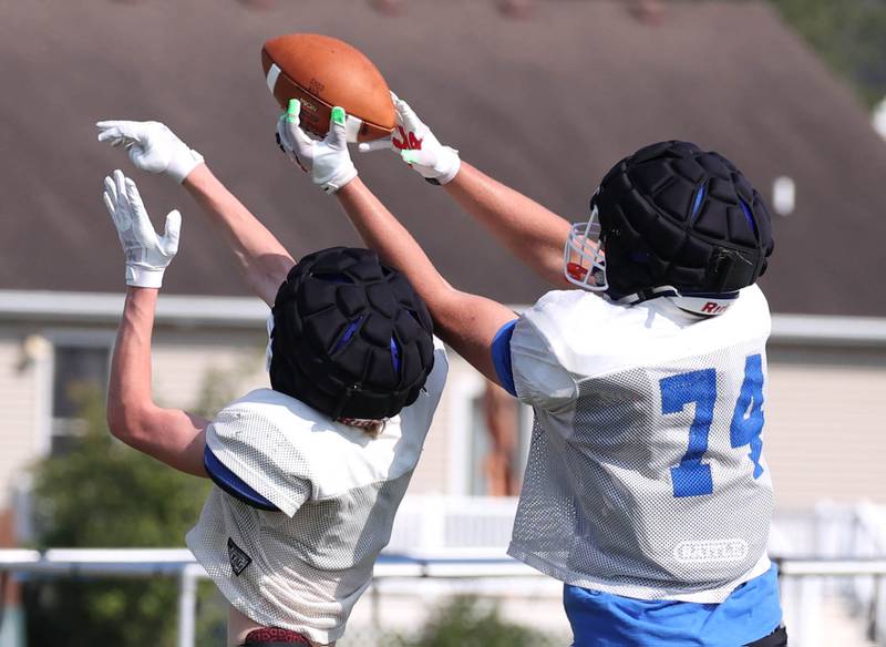 Genoa-Kingston’s Hayden Hodgson (right) goes up to try and catch a pass during practice Wednesday, Aug. 14, 2024, at the school in Genoa.