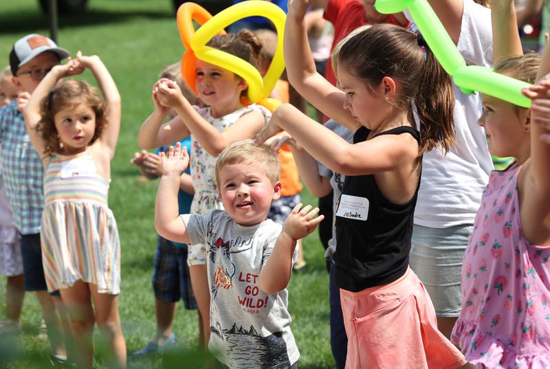 Kids do some dancing to the music played by “Mr. Steve,” Steve Lundquist, at the gazebo Saturday, July 15, 2023, during the Waterman Lions Summerfest and Antique Tractor and Truck Show at Waterman Lions Club Park.