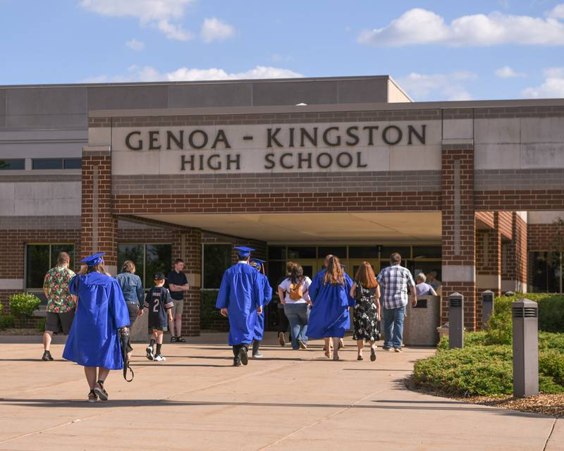 Graduates and commencement attendees walk into Genoa-Kingston High School before the start of the 2024 graduation ceremony held on Saturday May 18, 2024.