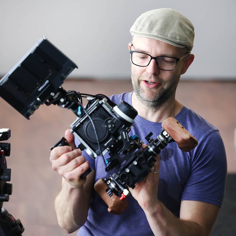 Seth Deming, with the group Write Film Edit and director for their latest project, sets up a camera for a shoot Thursday, May 16, 2024, in the studio at OC Creative in DeKalb.