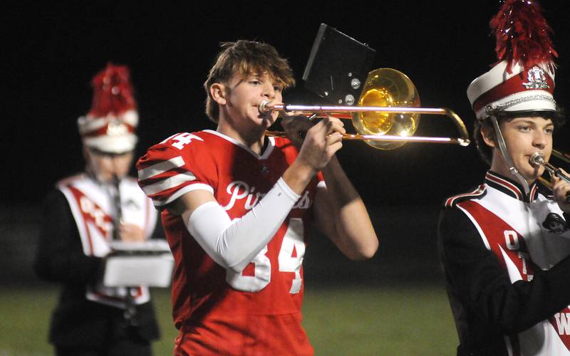 Ottawa varsity football player Owen Sanders performs in the marching band at halftime at King Field on Friday, Sept. 15, 2023.