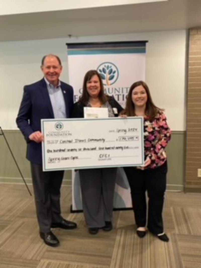 Rita Hanna, Princeton Theater Group Board member, accepts a check from Mark Roberts, Community Foundation of Central Illinois president and CEO and Sarah Fletcher, director of Grants and Community Initiatives.