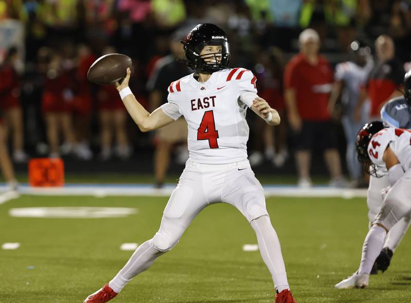 Glenbard East's Michael Nee (4) drops back to pass during the varsity football game between Glenbard East and Willowbrook high schools on Friday, Sep. 30, 2024 in Villa Park.