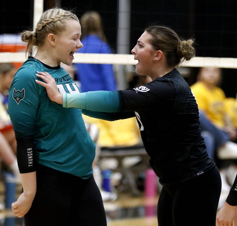 Woodstock North's Maddie Sofie hits her teammate, Devynn Schulze, as they celebrate a point during a Kishwaukee River Conference volleyball match against Johnsburg on Wednesday, Sept. 4, 2024, at Woodstock North High School.