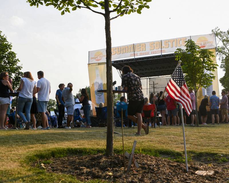 An American flag is placed next to James M. Mrazek memorial tree as the Summer Solstice music festival takes place on Friday June 23, 2023 in Yorkville.