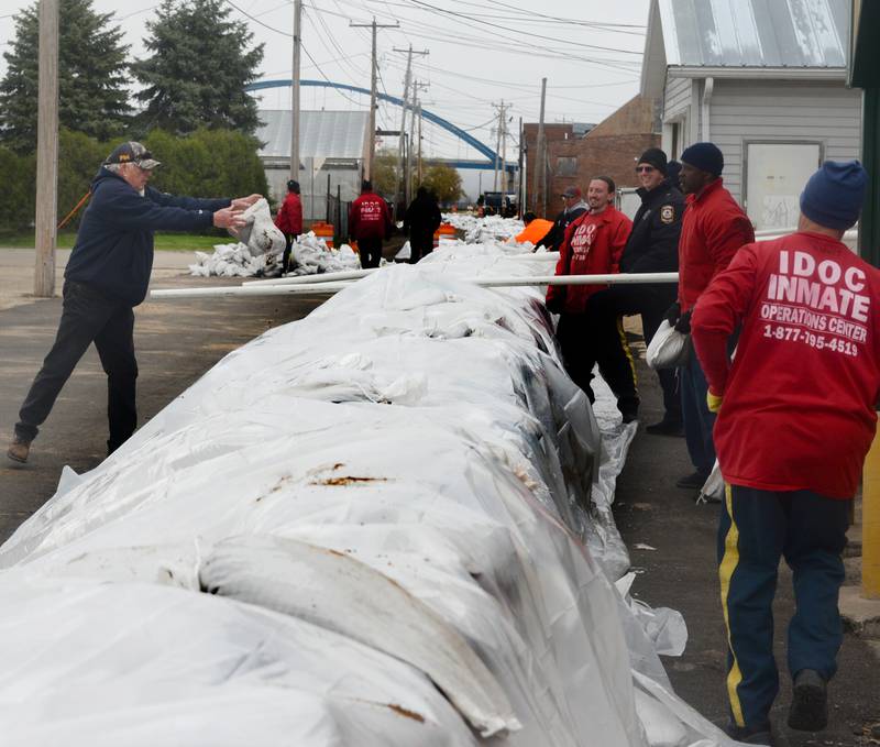 Savanna firefighter Gene Gonyier and inmates from Kewanee were busy placing sandbags behind the downtown business district on Saturday as Mississippi River levels continued to rise. The river was expected to crest at 22' laster this week. Flood stage is 16'. The 2019 flood reached 21', Savanna officials began preparing for the flood several weeks ago.