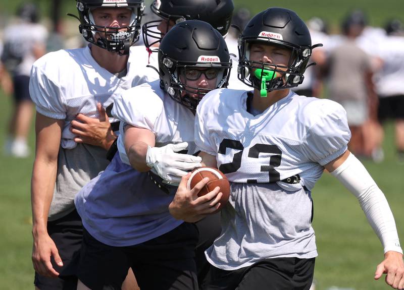 Sycamore’s Dylan Hodges carries the ball Monday, July 15, 2024, during summer football camp at Sycamore High School.