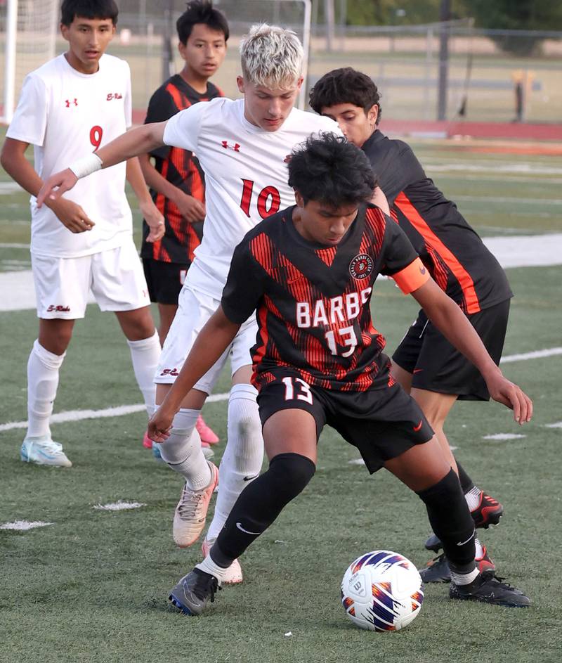 DeKalb's Henry Garcia-Alvarez holds off Rockford East's Aidan Aarli during their game Thursday, Sept. 12, 2024, at DeKalb High School.