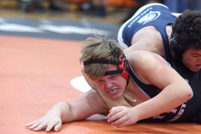 Prairie Ridge’s Walter Pollack tries to escape Cary-Grove’s Logan Sowell in a 220-pound bout during IHSA Class 2A regional wrestling at Crystal Lake Central Saturday. Sowell won the bout.