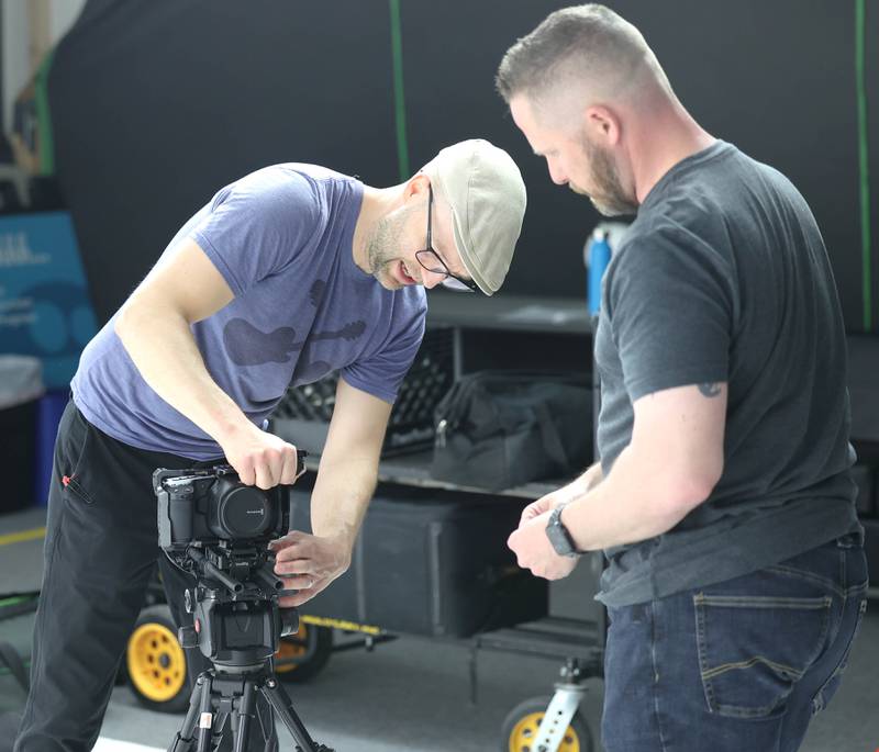 Seth Deming, with the group Write Film Edit and director for their latest project, sets up a camera with assistant Derek Hawkins Thursday, May 16, 2024, in the studio at OC Creative in DeKalb.