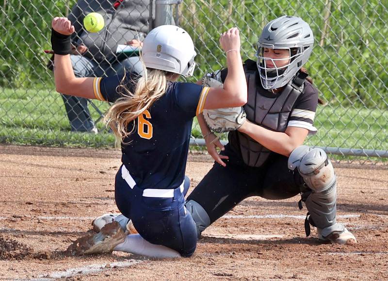 Sterling's Olivia Melcher scores on a close play as Sycamore's Kairi Lantz tries to corral the throw during their game Tuesday, May 14, 2024, at Sycamore High School.