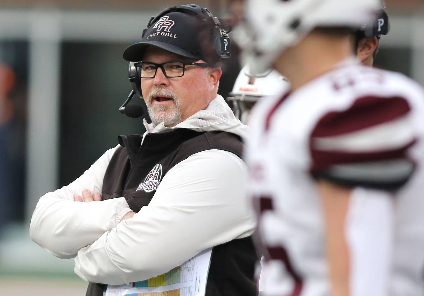 Prairie Ridge's head coach Chris Schremp talks to his players during their IHSA Class 6A state championship game Saturday, Nov. 26, 2022, in Memorial Stadium at the University of Illinois in Champaign.
