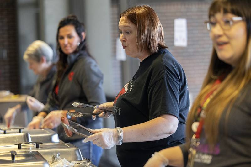 Kathy Sotelo, administration assistant to the dean of student services and business and community education, hands out hot dogs and hamburgers Wednesday, Jan. 31, 2024, at SVCC’s Sauk Fest.