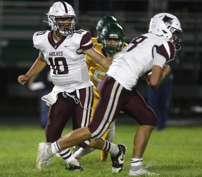 Prairie Ridge's Owen Satterlee hands the ball off to running back Jake Wagler during a Fox Valley Conference football game against Crystal Lake South on Friday, Sept. 6, 2024, at Crystal Lake South High School.