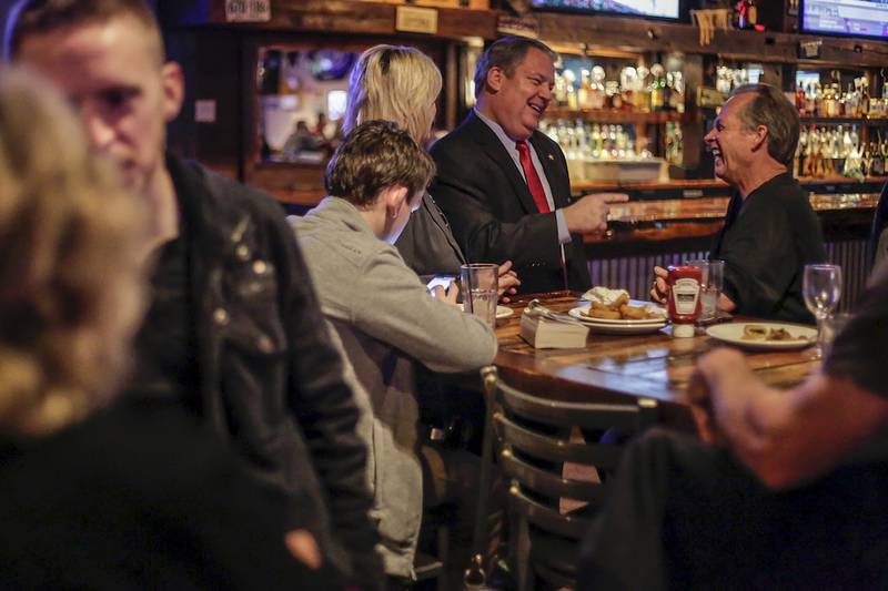 Will County Sheriff candidate Ken Kaupas (center) talks with Dave Chobar of Plainfield at an election night party Tuesday in Shorewood.