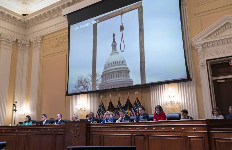 An image of a mock gallows on the grounds of the U.S. Capitol on Jan. 6, 2021, is shown as committee members from left to right, Rep. Stephanie Murphy, D-Fla., Rep. Pete Aguilar, D-Calif., Rep. Adam Schiff, D-Calif., Rep. Zoe Lofgren, D-Calif., Chairman Bennie Thompson, D-Miss., Vice Chair Liz Cheney, R-Wyo., Rep. Adam Kinzinger, R-Ill., Rep. Jamie Raskin, D-Md., and Rep. Elaine Luria, D-Va., look on, as the House select committee investigating the Jan. 6 attack on the U.S. Capitol holds its first public hearing to reveal the findings of a year-long investigation, at the Capitol in Washington, Thursday, June 9, 2022. (AP Photo/J. Scott Applewhite)