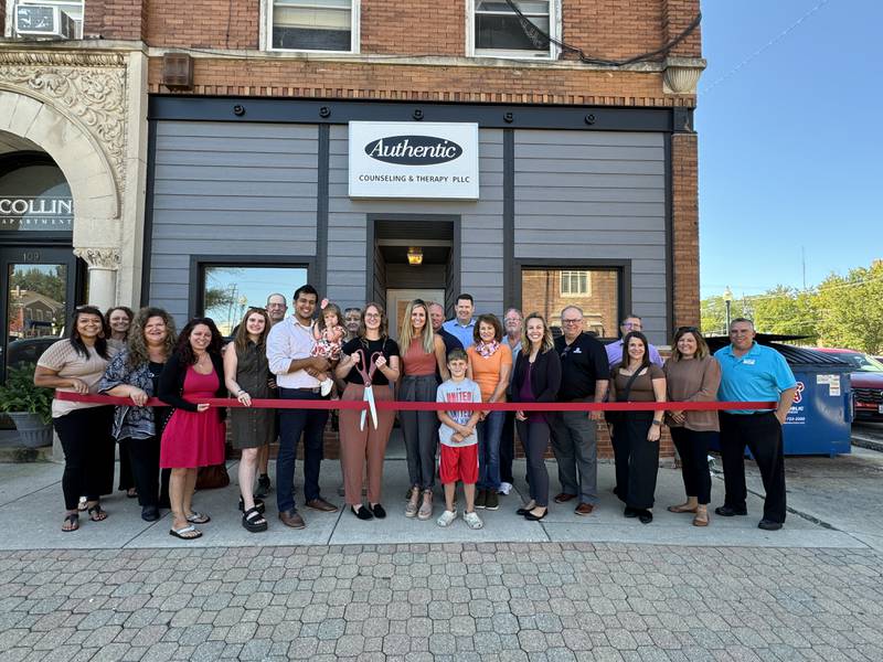 Authentic Counseling and Therapy, PLLC owners Christina Christensen and Jessica Anderson-Gonzalez (center) celebrate with their families, Morris Mayor Chris Brown, City of Morris staff, Chamber staff and members during a Grundy County Chamber ribbon cutting held Sept. 4 at their new downtown Morris office.