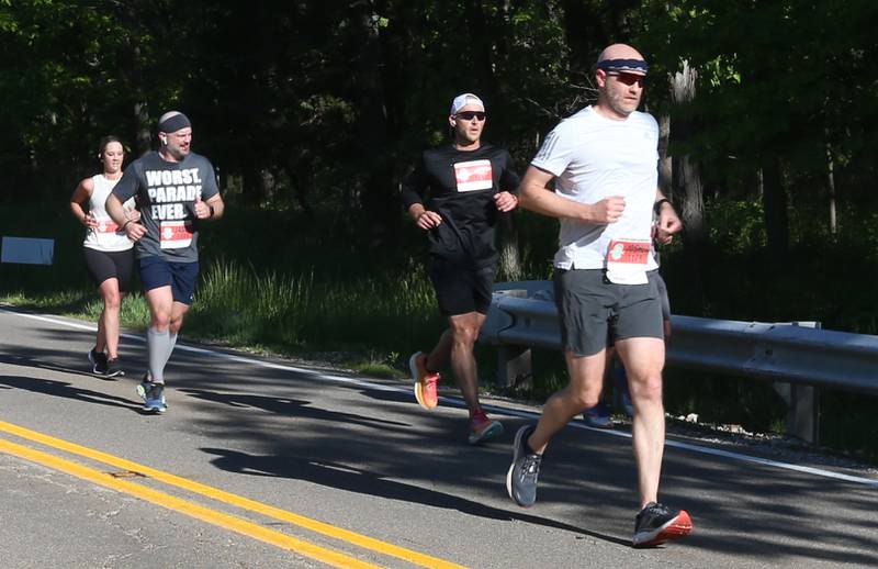 (From left) Sarah Gunderson of Ottawa, Jason Karun of Bloomington, Tim Jacobs of Sterling and Joshua Schmidt of Charlotte N.C. run during the Starved Rock Marathon and Half Marathon on Saturday, May 11, 2024 at Starved Rock State Park.