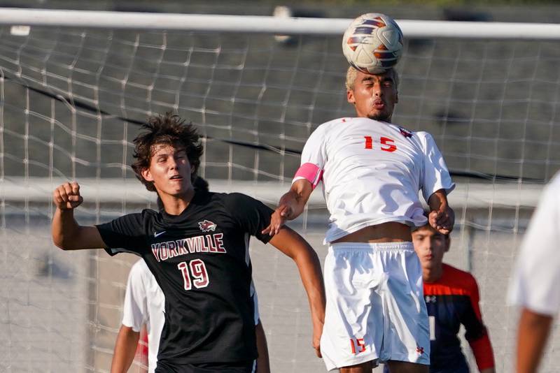 Oswego’s Noe Parra (15) goes up for a header against Yorkville's Kyle Nadler (19) during a soccer match at Yorkville High School on Tuesday, Sep 17, 2024.