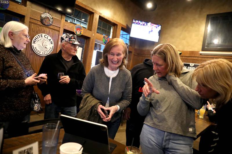 Barbara Wojnicki (center), candidate for Campton Hills Village President, smiles with friends at the Old Towne Pub in Campton Hills as they await election results following the Consolidated Election on Tuesday, April 4, 2023.