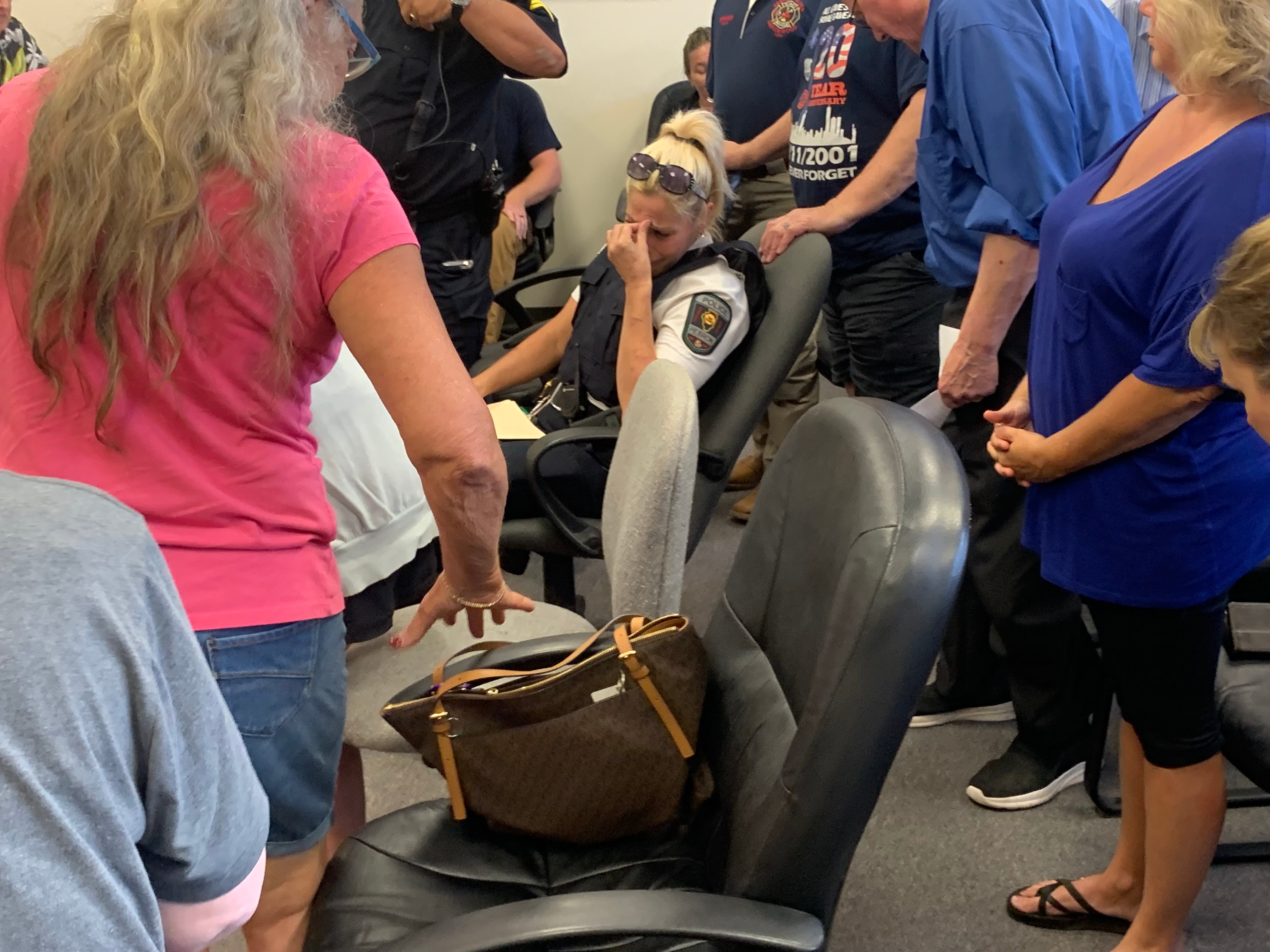 Hebron Police Chief Juanita Gumble is surrounded by supporters a village board meeting at which the board voted to dismiss her on July 22, 2024.