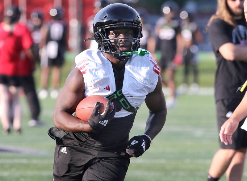 Northern Illinois Huskies running back Antario Brown carries the ball during a drill at the teams first practice of the season Wednesday, Aug. 2, 2023, at Huskie Stadium in DeKalb.