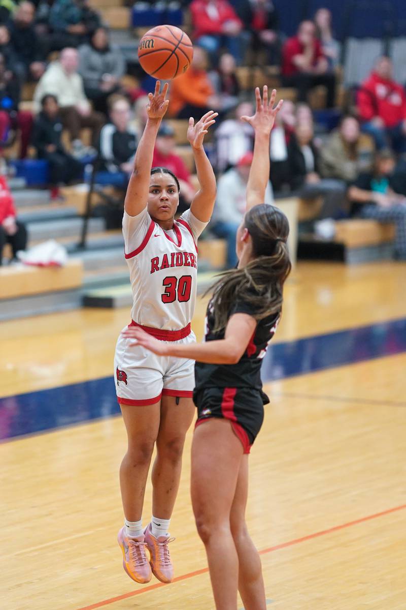Bolingbrook's Angelina Smith (30) shoots a three pointer against Benet’s Emilia Sularski (35) during a Oswego semifinal sectional 4A basketball game at Oswego High School on Tuesday, Feb 20, 2024.
