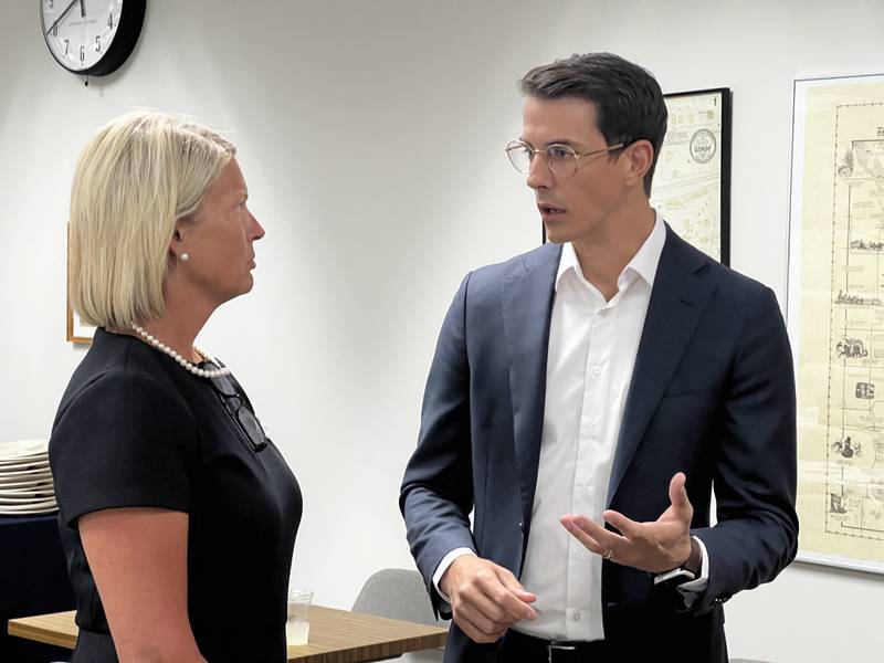 Genoa Mayor Jonathon Brust talks with House Minority Leader Tony McCombie, R-Savanna, during a legislative luncheon organized by the Genoa Chamber of Commerce on Aug. 21, 2024.