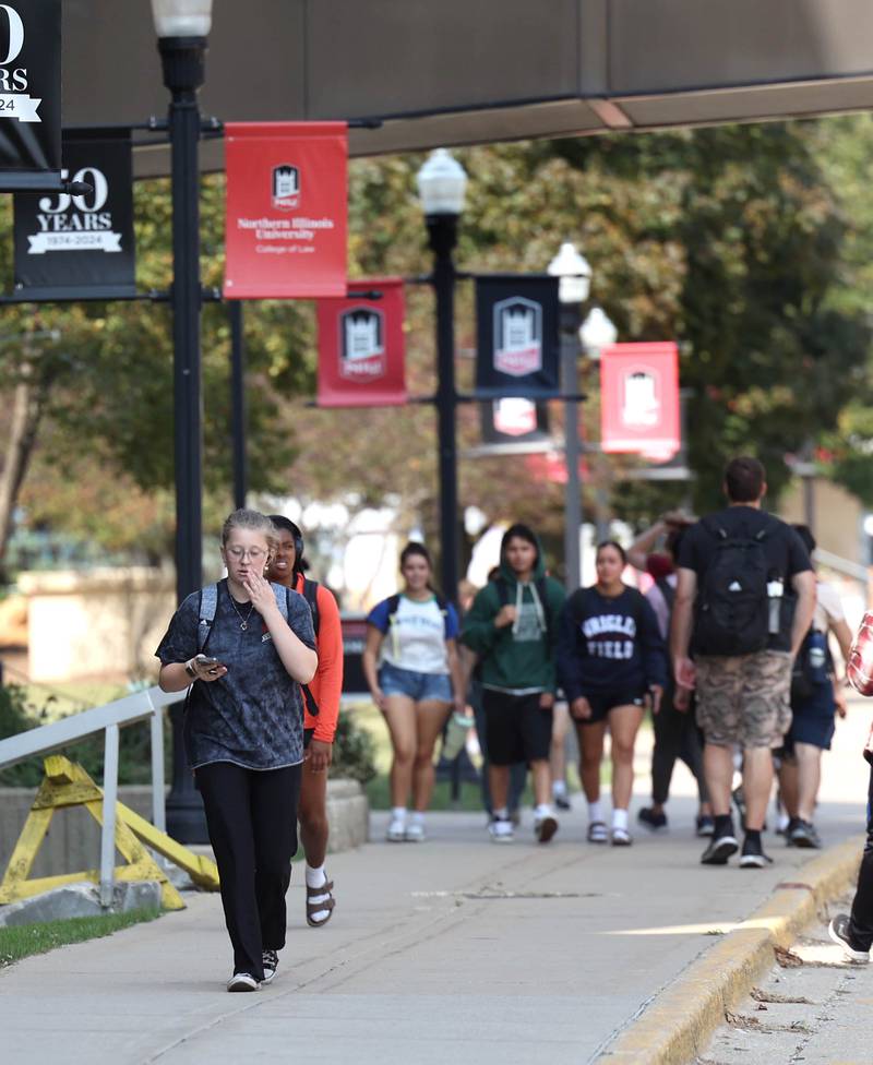 Northern Illinois University students walk down the sidewalk along Normal Road Thursday, Sept. 12, 2024, on campus at NIU in DeKalb.