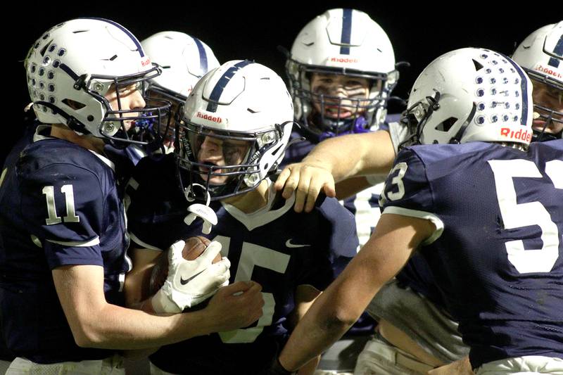 Cary-Grove’s Jake Hornok, center, is greeted in the end zone after scoring a touchdown against Libertyville  in first-round Class 6A playoff  football action at Cary Friday.