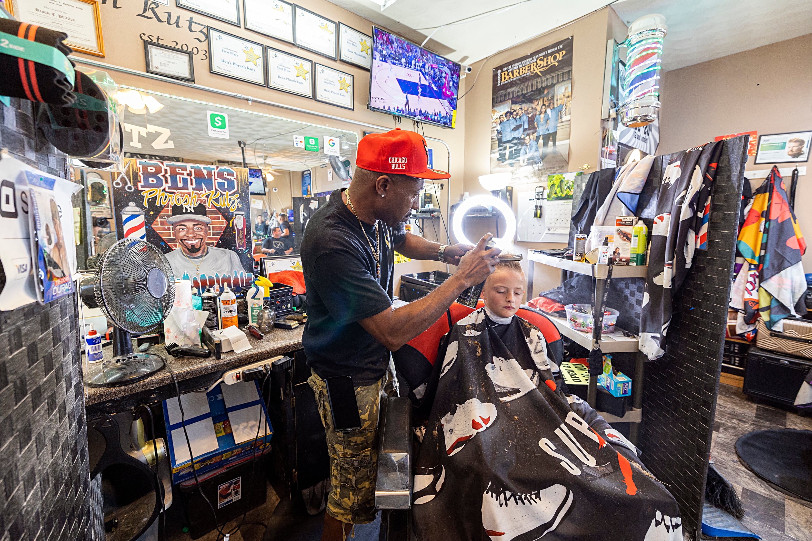 Ben Phillips gives Colton Lee, 7, a fresh new cut Tuesday, July 30, 2024 at Ben’s Phresh Kutz in Rock Falls. Phillips is gearing up for their Back 2 School Bash, an event held at the Rock Falls Community Building that offers $7 haircuts and back to school supply giveaways.