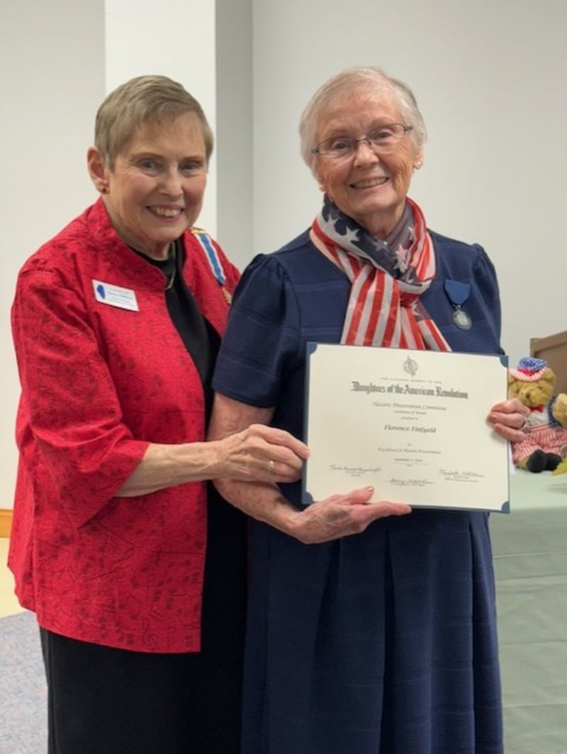 Florence Finfgeld, member of the Chief Senachwine Chapter National Society of Daughters of Revolution receives the Historic Preservation Certificate and Medal from Chapter Regent Nancy Gillfillan for her 40 years of volunteerism at the Marshall County Historical Society and Museum.