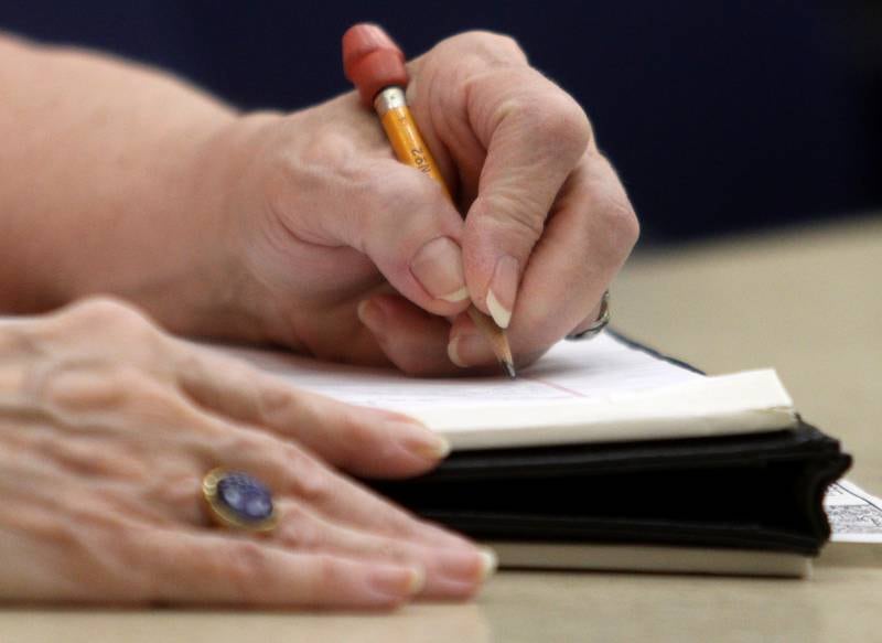 A member takes notes during a meeting of the McHenry County Illinois Genealogical Society on Thursday, March, 9, at McHenry County College. Thursday was the group’s first in-person meeting since before the pandemic.