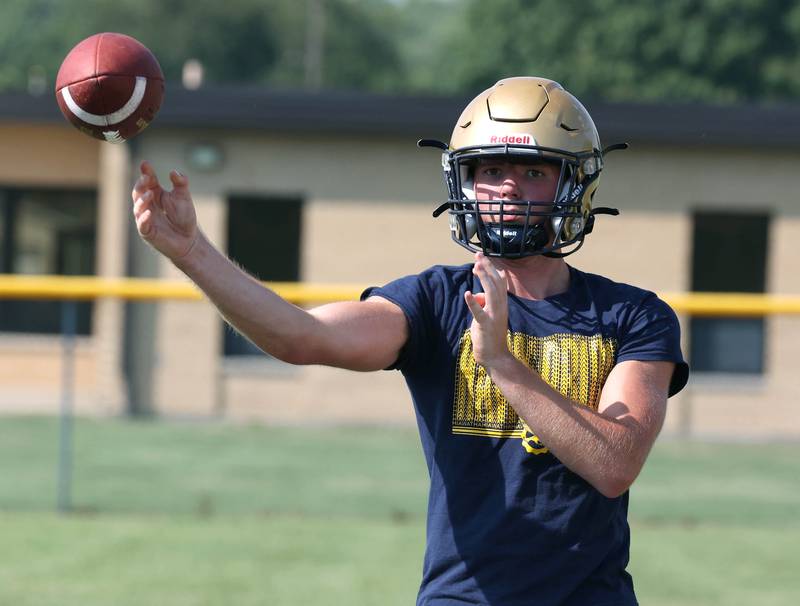 Hiawatha’s Aiden Cooper (left) throws a pass during practice Wednesday, Aug. 14, 2024, at the school in Kirkland.