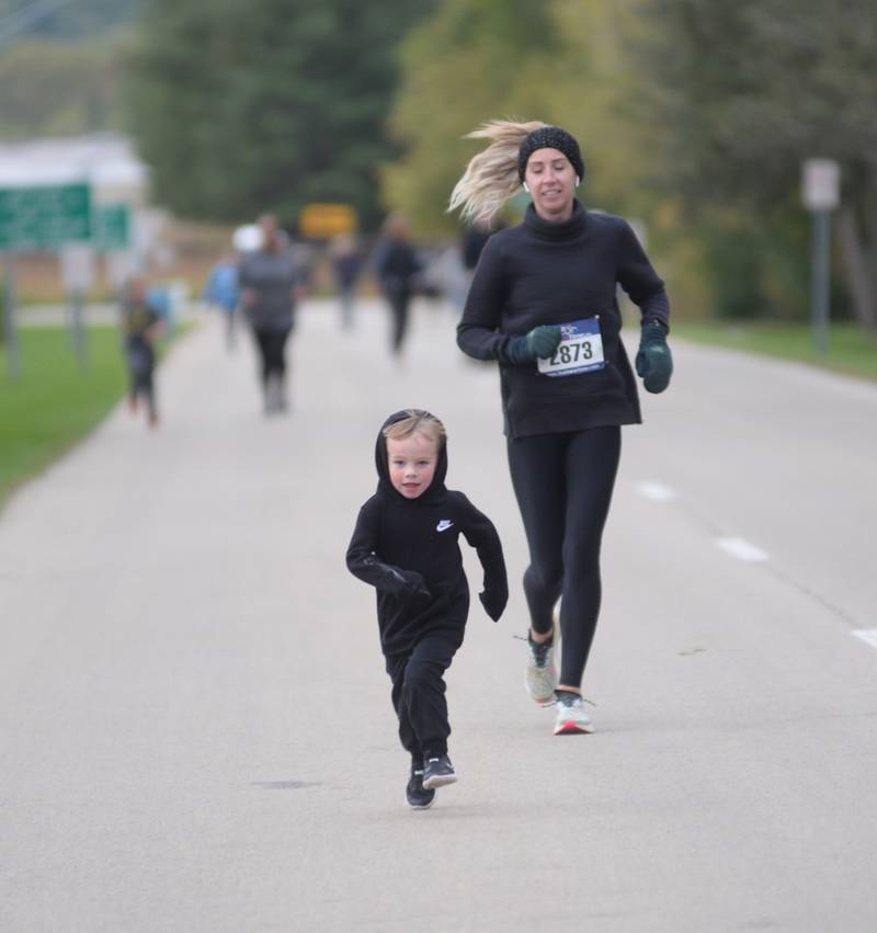 Jordan Willey, 3, of Dixon, runs ahead of his mom, Andrea, as they head to the finish line in the 1-Mile Fun Run during Autumn on Parade on Sunday, Oct. 8, 2023 in Oregon.