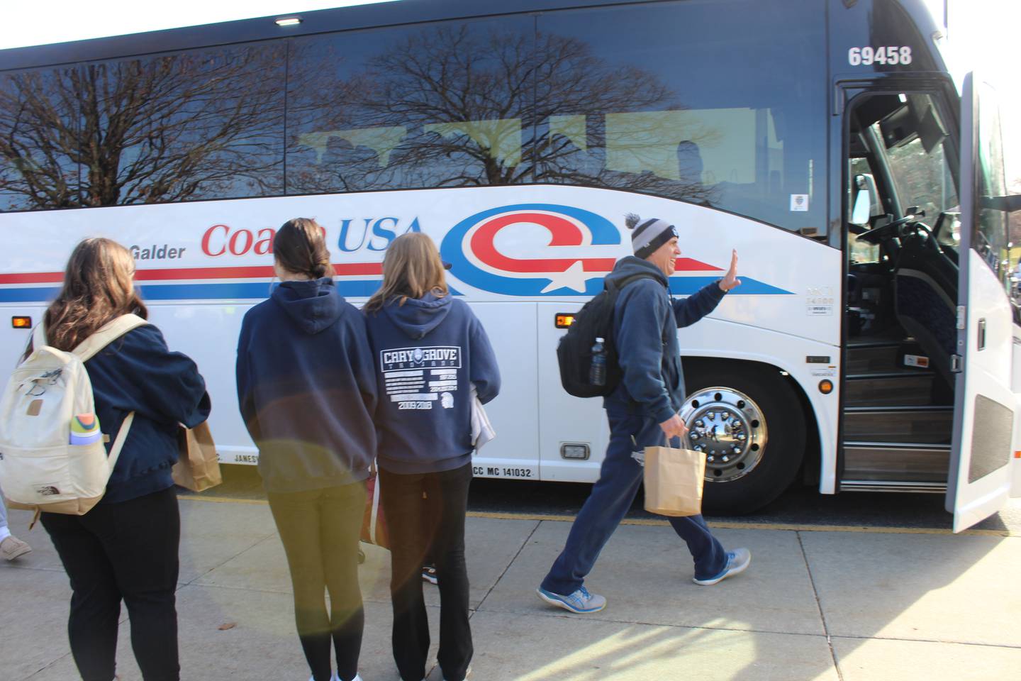 Coach Brad Seaburg boards the bus to the state championship game Friday.