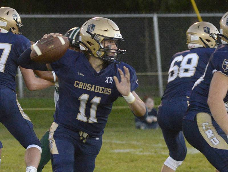 Marquette quarterback Anthony Couch looks for an open receiver in last season's game against Madison at Gould Stadium in Ottawa.