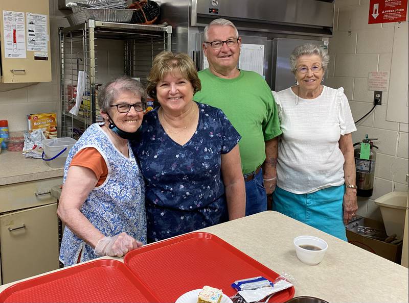 Volunteer chef Kerin Harris (far left) gathers in the Community Nutrition Network's kitchen at the Beecher Community Center with fellow volunteers, Susan and Howard Casner (middle) and Lois Konicek (far right).