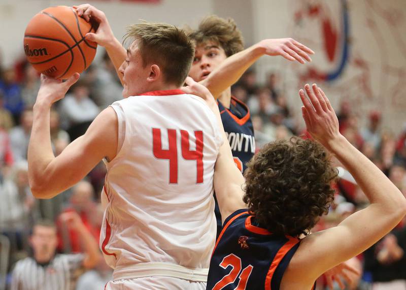 Streator's Nolan Lukach grabs a rebound over Pontiac's Kerr Bauman and teammate Riley Weber during the Class 3A Regional semifinal game on Wednesday, Feb. 22, 2024 at Pops Dale Gymnasium.