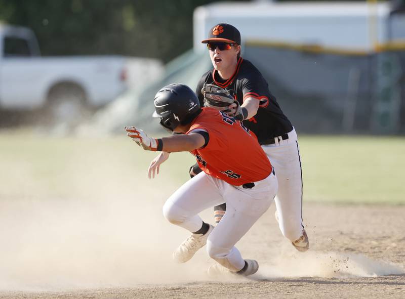 St. Charles East's Antonio Perez (26) gets caught stealing by Wheaton Warrenville South's Chris Myers (4) during the Class 4A York regional semi-final between Wheaton Warrenville South and St. Charles East in Elmhurst on Thursday, May 23, 2024.