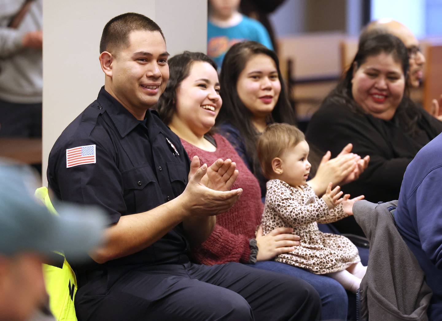 New Sycamore firefighter Carlos Aburto (left) and family applaud after fellow new firefighter KeeLey Meyer is officially sworn in by city clerk Mary Kalk Monday, April 1, 2024, during the Sycamore City Council meeting in the chambers at Sycamore Center.