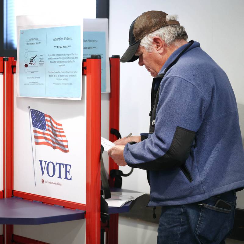 Mike Knowlton, from DeKalb, casts his ballot Tuesday, March 19, 2024, in the polling place at the DeKalb County Administration Building in Sycamore.