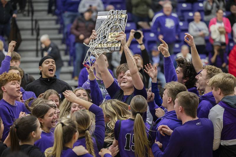 Dixon’s Jessie Pitman holds the plaque high in celebration after the Duchesses defeated Boylan Friday, Feb. 16, 2024 at the class 3A Rochelle girls basketball regional.