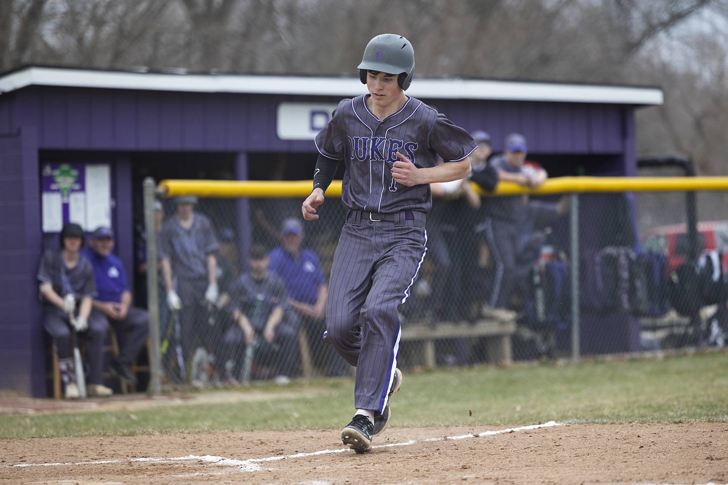 Dixon’s Alex Harrison takes home on a wild pitch against Rockford Jefferson Wednesday, March 13, 2024 to open the Dukes’ baseball season.