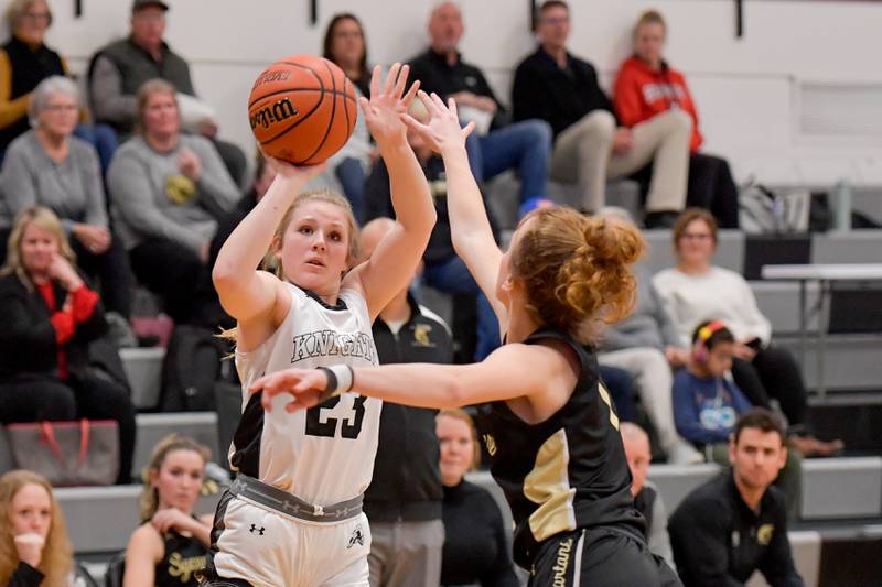 Kaneland's Kendra Brown (23) takes a shot over Sycamore's Mallory Armstrong (1) during a game in Maple Park on Wednesday, Dec. 7, 2022.