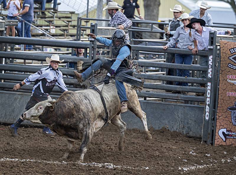 Keith Hall lets loose after making a qualifying ride in the Rice Bull Riding and Barrel Racing event Thursday, August 11, 2023 at the Carroll County fair.