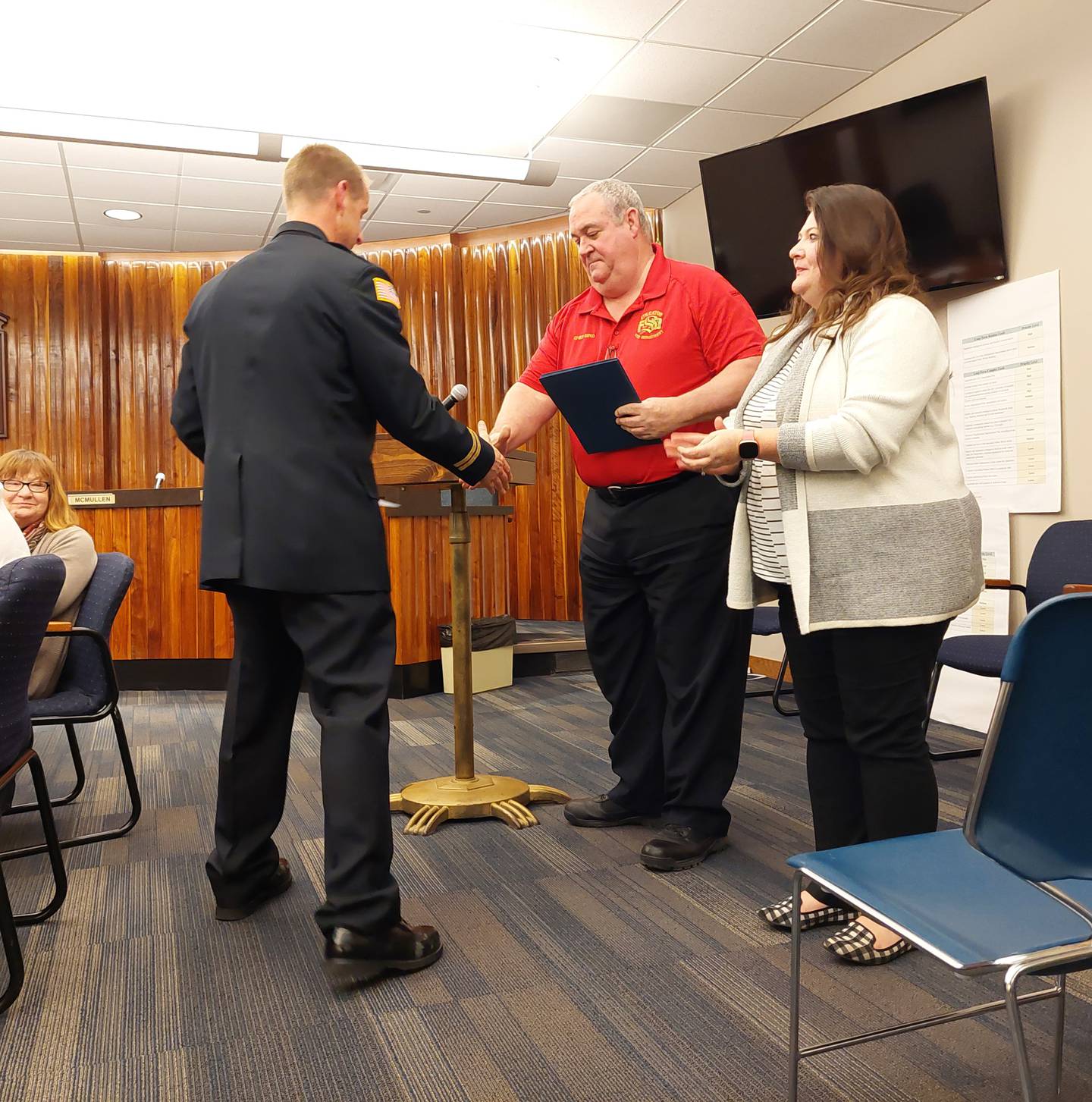 Streator Fire Chief Gary Bird and Mayor Tara Bedei congratulate Fire Capt. Ryan Reynolds, who was one of eight firefighters and paramedics, recognized Wednesday, Feb. 21, 2024, during the City Council meeting for saving the life of a fire victim earlier this year.