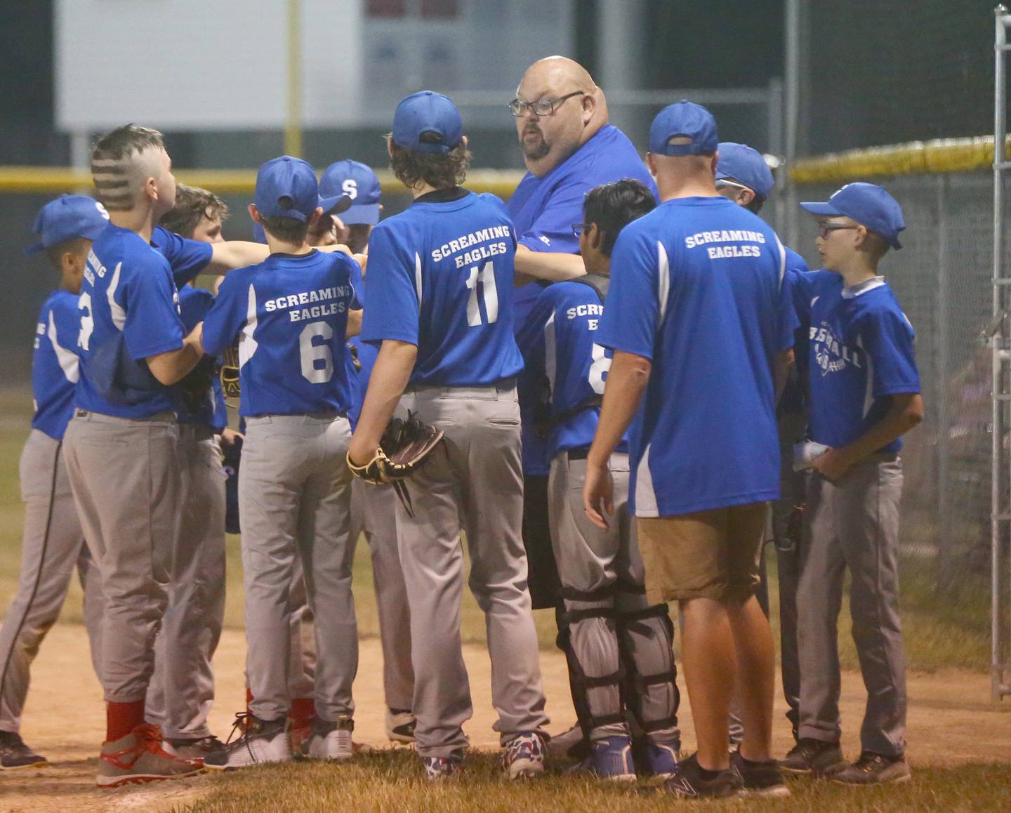 The Screaming Eagles talk things over between innings of the Streator Major city championship game Wednesday, June 29, 2022, at Southside Diamond.