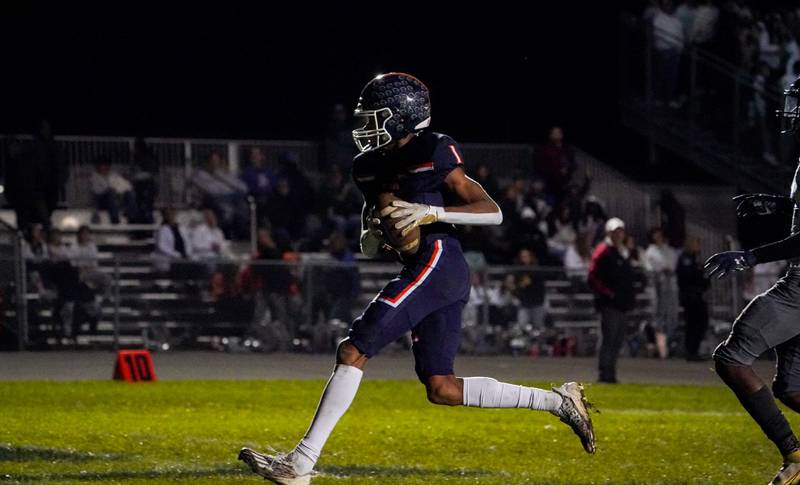 Oswego’s Jeremiah Cain (1) runs after the catch for a touchdown against Oswego East during a football game at Oswego High School on Friday, Oct. 20, 2023.