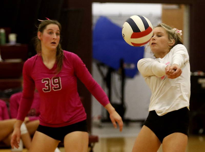 Richmond-Burton's Lanee Cooley passes the ball forward in front of her teammates,Maggie Uhwat, during a Kishwaukee River Conference volleyball match against Woodstock North Wednesday, Oct.11, 2023, at Richmond-Burton Community High School.